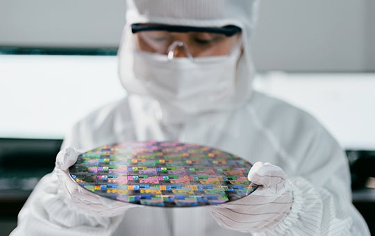 Micron team member holding a wafer